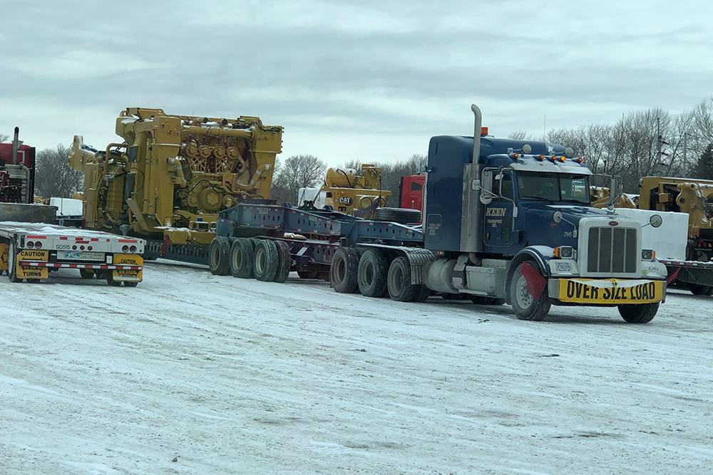 Coordinating Safe and Efficient Oversized Load Transport with Pilot Car Teams in North America